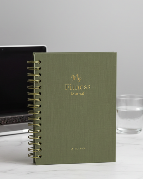 Green fitness journal with 'My Fitness Journal' text on a marble background