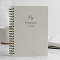 Open notebook with 'My Prayer Journal' on a marble surface next to a steaming mug.