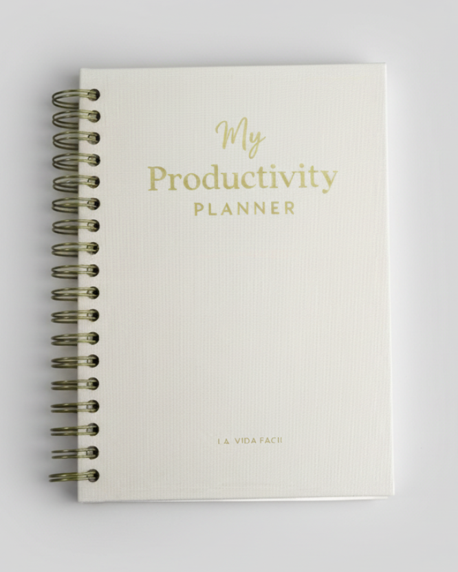 Productivity planner with gold text on a marble surface