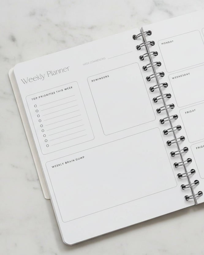 Weekly planner with spiral binding on a light surface